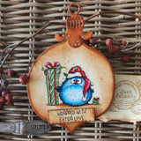 Ornament card with a round blue bird in a Santa hat holding a gift, 'Wrapped with extra love.'