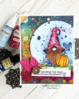 A splattered blue and pink card with the gnome colored in red and purple beside his orange pumpkin, in a circle panel, with a strip reading 'Sending fall feels'.