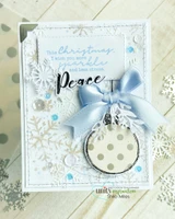 Card with the round ornament filled with gray polka dot paper, a pale blue bow and snowflakes, with 'Peace'.