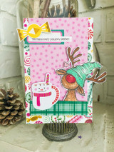 Card with the reindeer in a teal cap over pink hot-cocoa papers and 'You make every season sweeter.'