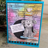 Bright blue card with a rainbow-inked bookshelf background: the pup in gray sits on a black circle under the books-brews-best-friends sentiment.