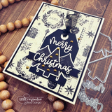 Navy and cream Christmas card with a vintage holiday print background, a navy tag with white Merry Christmas script, and gold brads on a tree die-cut.