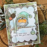 Card with the bird in a mint knit hat and blue plaid scarf on a scalloped white panel over woodgrain patterned paper, pinecones and greenery around it, sentiment "The season shines brighter when you're near."