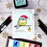 Card with the bird colored butter yellow in a red pom hat on a soft blue panel, alcohol markers and an ink pad laid beside it, sentiment "The season shines brighter when you're near."