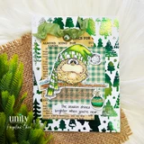 Card with the bird in a green knit hat layered on green plaid and tree-print paper with vintage book text behind, sentiment "The season shines brighter when you're near."