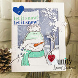Snowman colored in green on a snowy birch panel with 'let it snow! let it snow!'