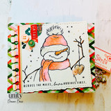 Snowman on a colorful patterned card holding a heart with 'Across the miles, love arrives first.'