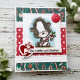 Card with the skunk on red floral papers above 'Have a stinkin' sweet Christmas'.