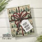 Card of a deep red bow over tree-print paper, tag 'Merry Merry Merry.'