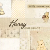 Honey and Heart paper pack in overlapping sheets of cream and butter yellow: honeycomb hearts, handwriting script prints, drifting bees, and a classic teddy bear with his honey pot, labeled UP-HAH-219.