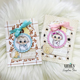 Two coordinating Honey & Heart baby cards side by side, one in aqua and one in pink, each layering a colored baby image over teddy-bear print papers with a grosgrain bow.