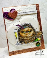 Copper glitter card with a heart embellishment and a warmly colored Pissy Kitty raising a champagne flute, stamped 'Nine lives, zero resolutions.'