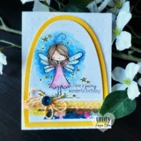 Card with a yellow arch die-cut over a blue sky, the fairy in a pink dress, and 'Have a fairy wonderful birthday' below.