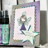 Shimmery card with the fairy in a purple dress, teal star die cuts, and 'Twinkle on, sweet girl.' on a banner.
