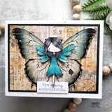 Card with the fairy in a teal dress over enormous blue butterfly wings on woodgrain paper, with 'Have a fairy wonderful birthday' beneath.