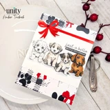 Card of three puppies peeking over a black-and-white plaid panel with a red bow, 'just a hello'.