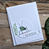 A cardmaking project featuring a snarky green grasshopper from Unity Stamp Co's Starting a Plague red rubber stamp set, with the sentiment 'That's it. I'm starting a plague.'.