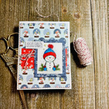 Card with the snowman in a colorful hat over a snow-globe print, 'Your gift made my holiday sparkle.'