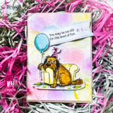 A colored card featuring a tired, hungover shaggy dog in a party hat slumped by a balloon and gift from Unity Stamp Co's Party Pup red rubber stamp set, with the sentiment 'Congratulations'.