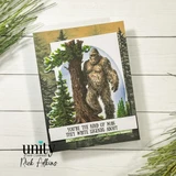 Card with the Sasquatch stamped over layered forest papers and 'You're the kind of man they write legends about' on a white strip.