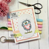 Pastel card with the fluffy bird holding a pink heart in an oval and 'LOVE. just because.'