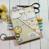 A handmade card featuring a wide-eyed, smiling cartoon bumblebee from Unity Stamp Co's Peek-A-Bee red rubber stamp set, with the sentiment 'Bee-told your card has arrived!'.
