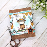 A colored card featuring a shaggy Highland cow with a little bird perched on its head, in a wildflower meadow from Unity Stamp Co's Seen & Herd red rubber stamp set, with the sentiment 'Sorry for being so moody!'.