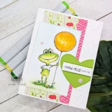 Card of the frog with a yellow balloon and a green die-cut heart reading "i toad-ally love ya."