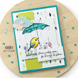 Teal-framed card with the bird under an umbrella and 'Rain makes room for things to bloom.'