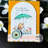 Arched card with the bird under a teal umbrella over yellow dots and 'Rain makes room for things to bloom.'