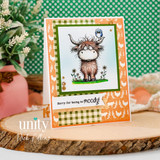 Card sample — a shaggy highland cow with a bird, 'sorry for being so moody!', on chicken-print and gingham papers.