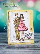 A yellow and cream card with the dressed up couple stamped arm in arm, the woman in a pink dress and the man in a tan suit, beside a small panel reading 'you have my HEART'.