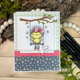 Card of the bird swinging from a branch over green and floral papers, 'you're as tweet as can be.'