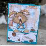 Card with the yawning bunny over coffee-cup papers and 'Living on a prayer and lots of coffee.'