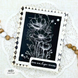 Dramatic card with the flowers stamped in white on black and 'Even now, hope blooms.'