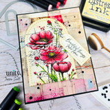 Card with the cosmos and poppies colored red and pink over collage papers and 'Beautiful things take time.'