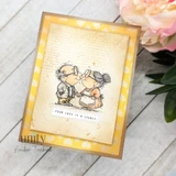 Card of the kissing couple over yellow script paper with "Your love is a legacy."
