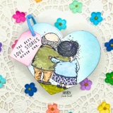 Card of the embracing couple over a blue heart with "The best love stories never end."