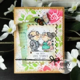 Card of the kissing couple over green foliage with "The best love stories never end."