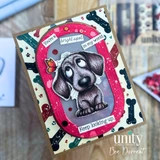 Handmade card featuring a cute, big-eyed puppy looking up at a butterfly, framed in a pink oval with splatter accents, set against a playful dog bone background, with the sentiment “You’re a bright spot in my world. Keep looking up.”
