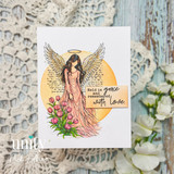 Handmade card featuring a graceful angel with outstretched wings and halo in a flowing gown, standing among tulips with a soft circular background, with the sentiment “Held in grace and remembered with love.”