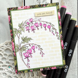 Bleeding heart floral card with pink blossoms, patterned borders, and the sentiment “you are loved.”