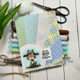 Handmade card with a grumpy goat and the sentiment, “You’ve goat to be kidding me,” surrounded by pastel patterned papers and crafting supplies.