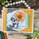 Apology card with skunk holding orange flower and “sorry stuff stinks” sentiment.