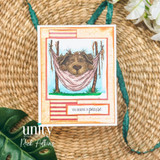 Encouragement card with a sleepy dog in a pink hammock and the sentiment, “You deserve a pause.”