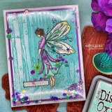 Shaker-style card with the fairy in a lavender gown over teal woodgrain with sequins.
