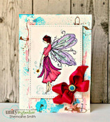 Mixed-media card with the fairy in a magenta gown and purple wings framed by a red flower and splatter.