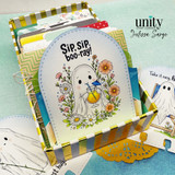 Ghost-themed pocket card with the sentiment “Sip sip, boo-ray!” displayed in a striped organizer box filled with colorful card inserts.
