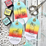 Three colorful summer cocktail gift tags with playful sentiments, ink-blended backgrounds, and twine hangers.