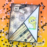A fun-fold card with a peeking mummy over spiderweb and text papers, 'tricky.'